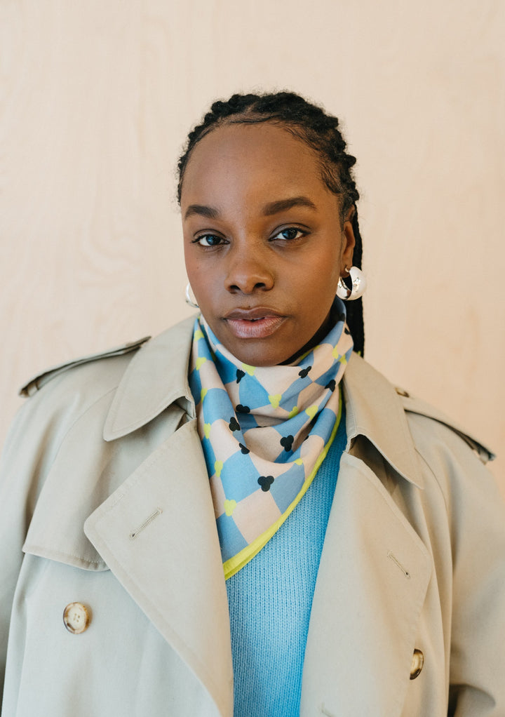 TBCo Cotton Square Scarf in Blue Checkerboard styled with beige trench coat and blue sweater for elegant spring layering