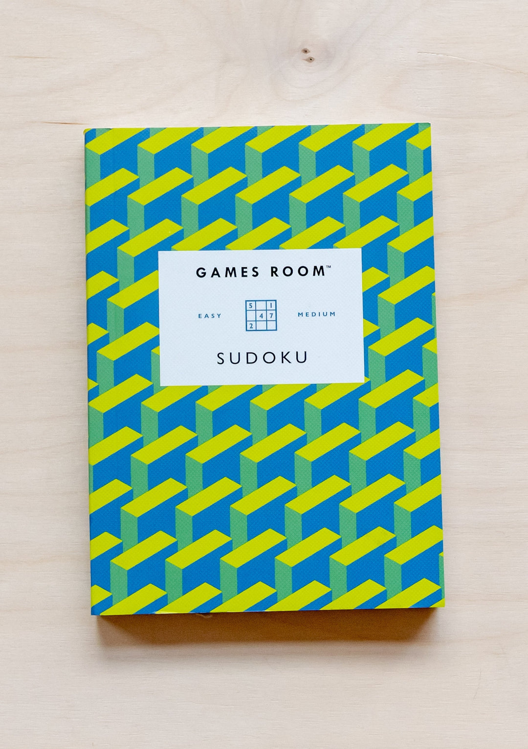 TBCo Games Room Sudoku puzzle book with blue and yellow geometric pattern cover, easy to medium difficulty puzzles