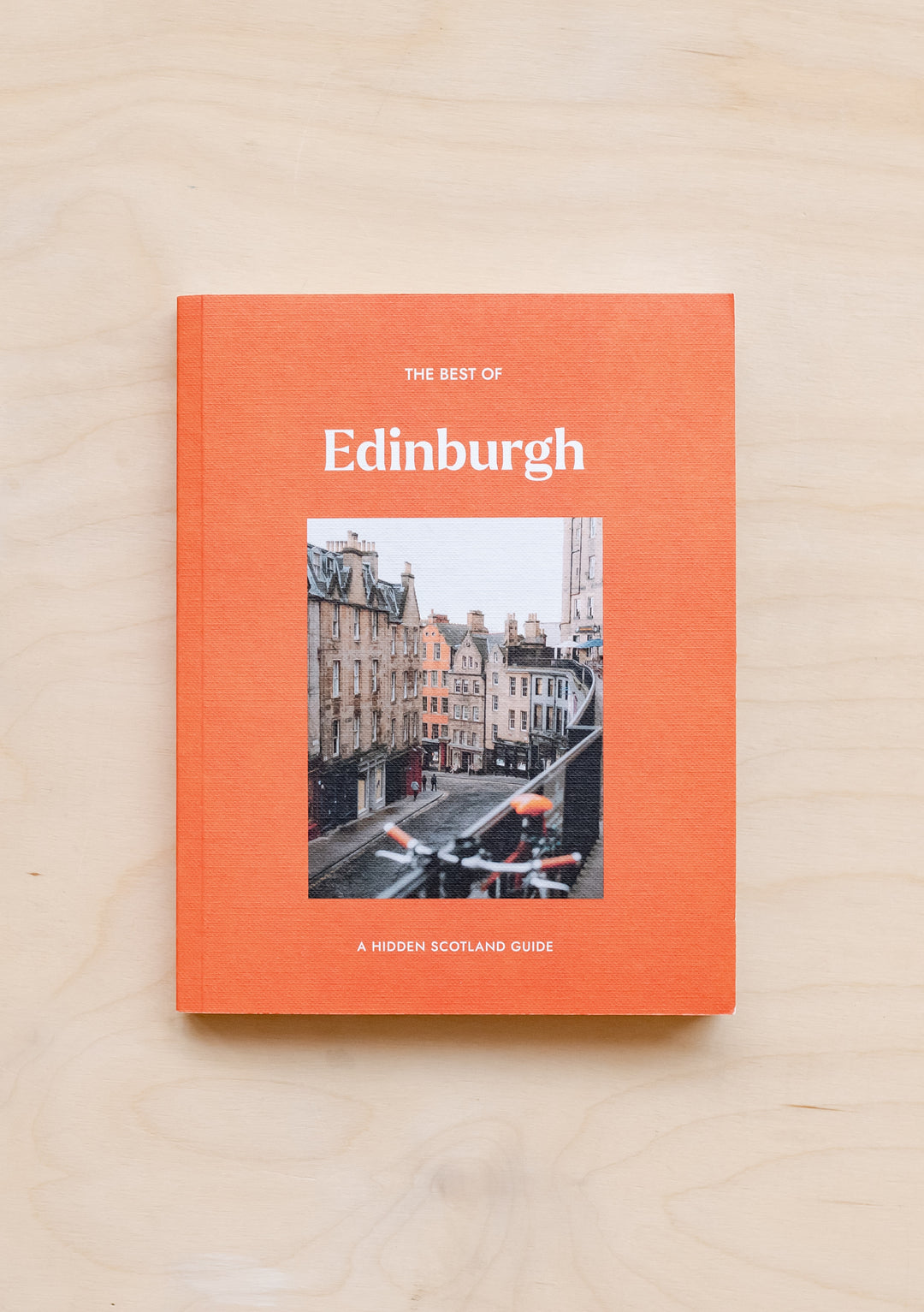 The Best of Edinburgh: A Hidden Scotland Guide by TBCo - Orange hardcover book featuring historic Edinburgh street photography