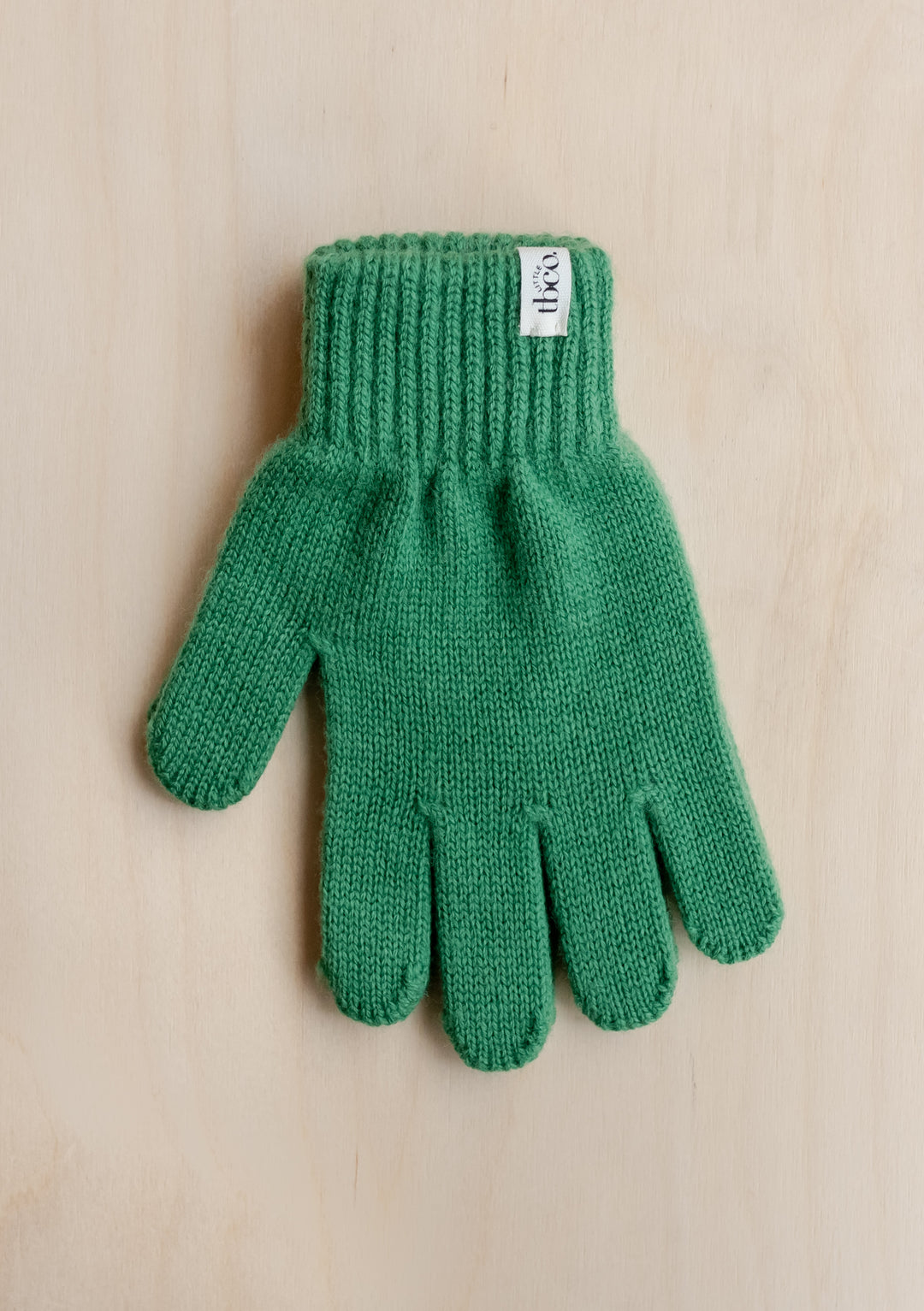 TBCo Merino Wool Kids Gloves in vibrant green with ribbed cuff, featuring soft knitted texture for winter warmth