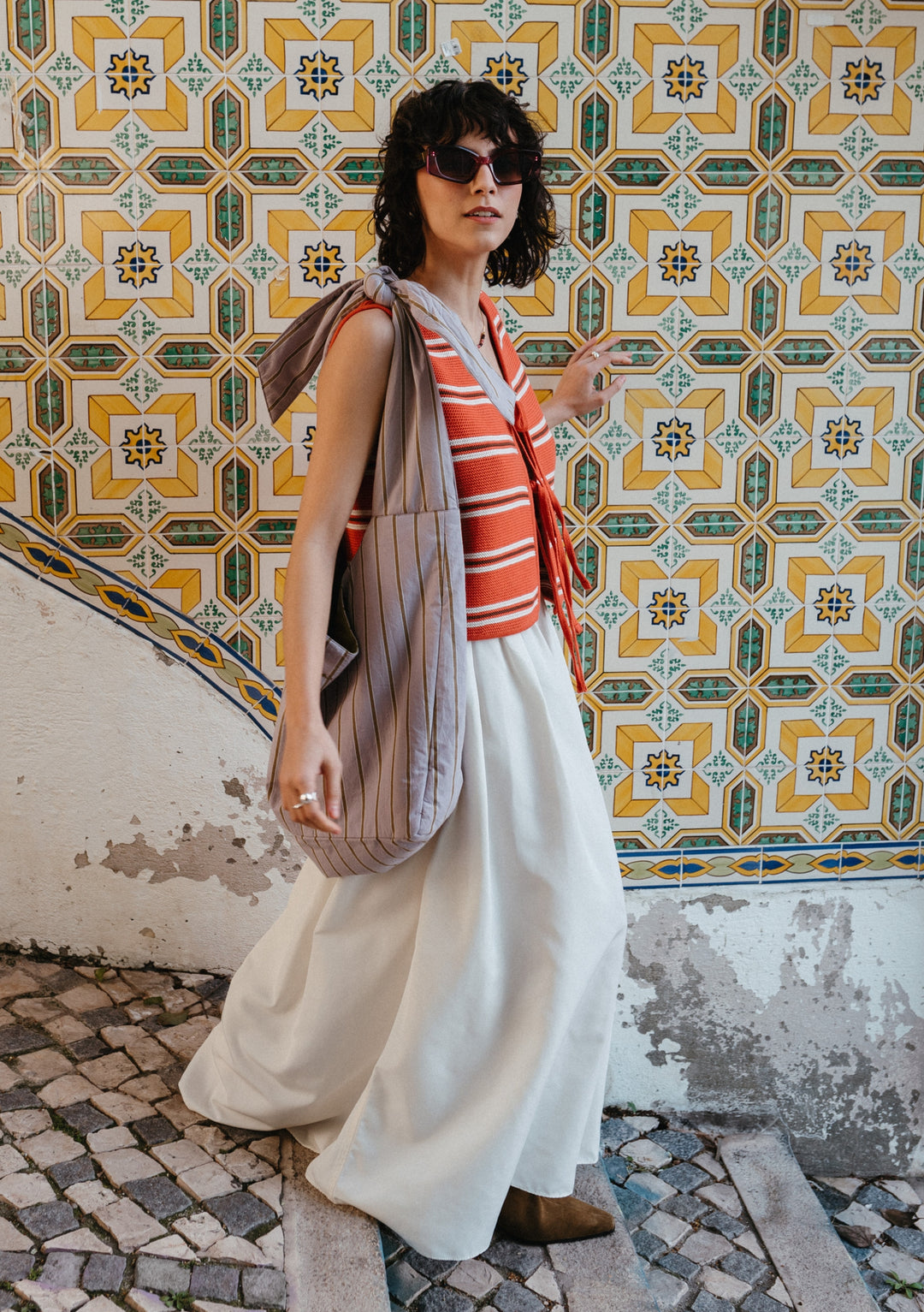 TBCo Large Cotton Multi Knot Bag in lilac stripe features adjustable design, shown against decorative tiled wall