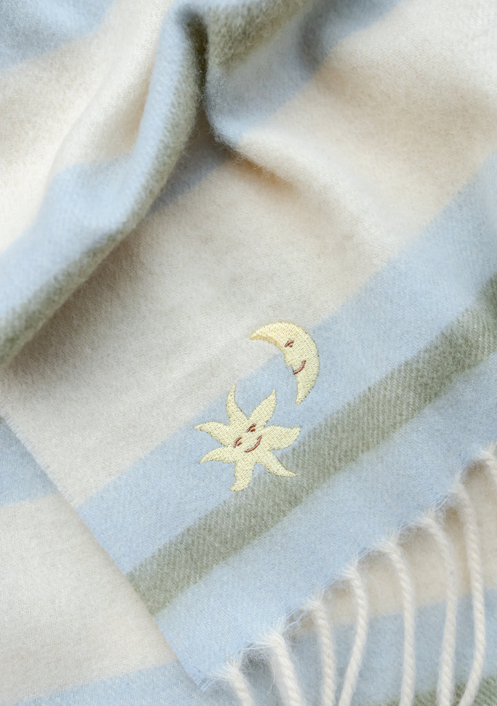TBCo Lambswool Baby Blanket in Blue Stripe with embroidered sun and moon detail on striped soft wool fabric