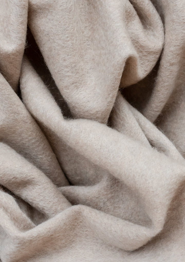 TBCo Men's Cashmere Scarf in Oatmeal Melange featuring soft, luxurious folds of pure cashmere fabric in a light beige tone