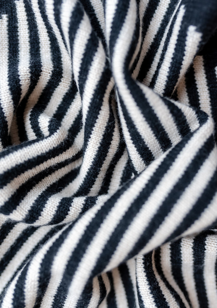Close-up texture of TBCo Merino Triangle Scarf in Black Stripe, showing soft knitted wool with diagonal black and cream stripes