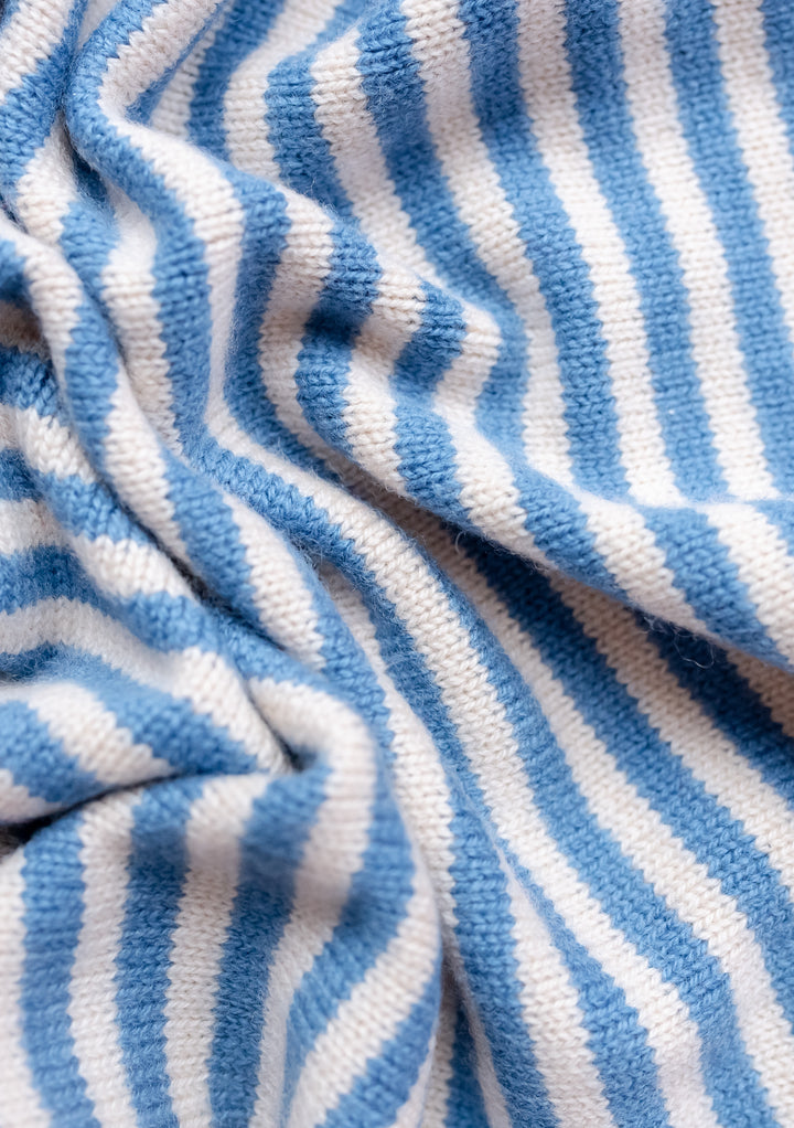 Close-up texture of TBCo Merino Triangle Scarf showing soft blue and cream stripes in knitted merino wool fabric