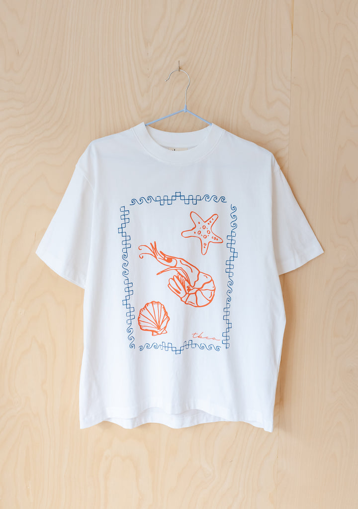 TBCo Cotton T-Shirt in White Shrimp featuring red sea creatures illustration with blue geometric border on white cotton tee