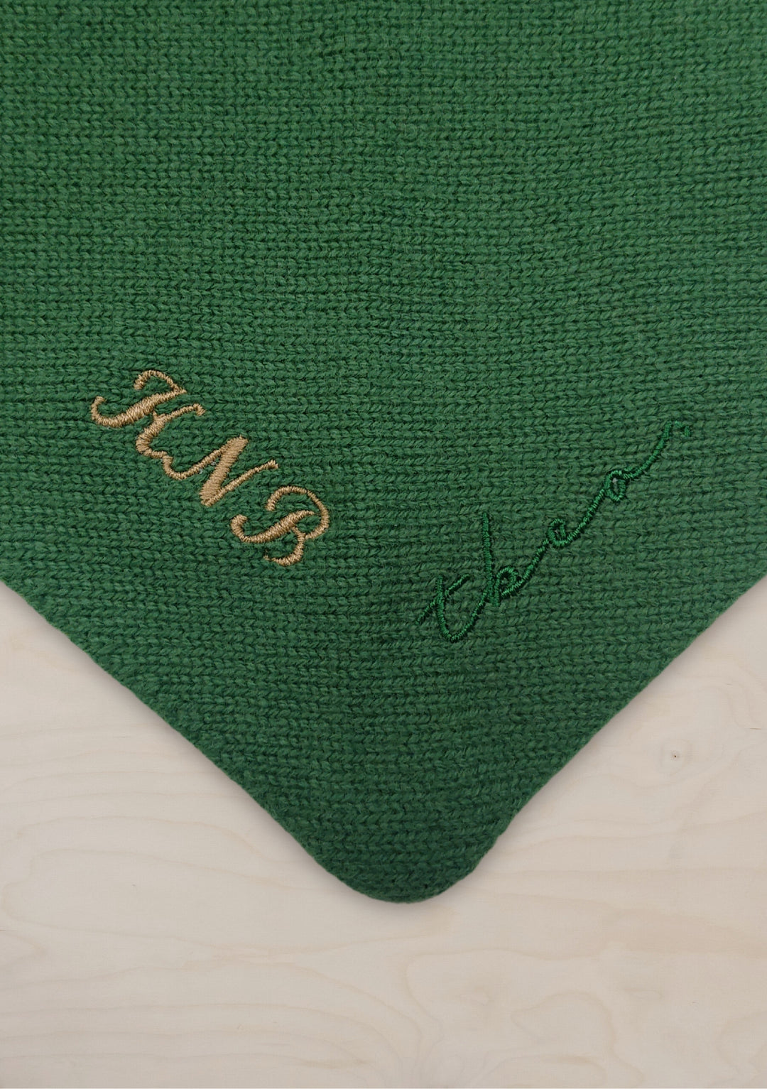 Green knitted merino wool triangle scarf from TBCo with personalised gold embroidered initials on corner detail