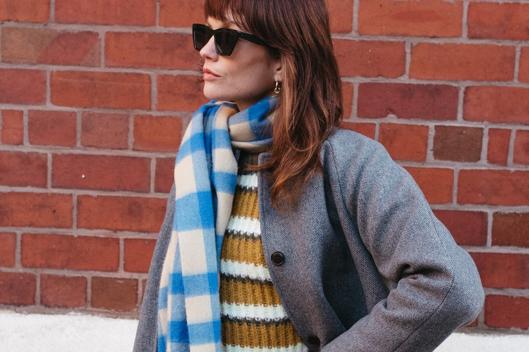 Model wears a TBCo blue and cream gingham lambswool oversized scarf.