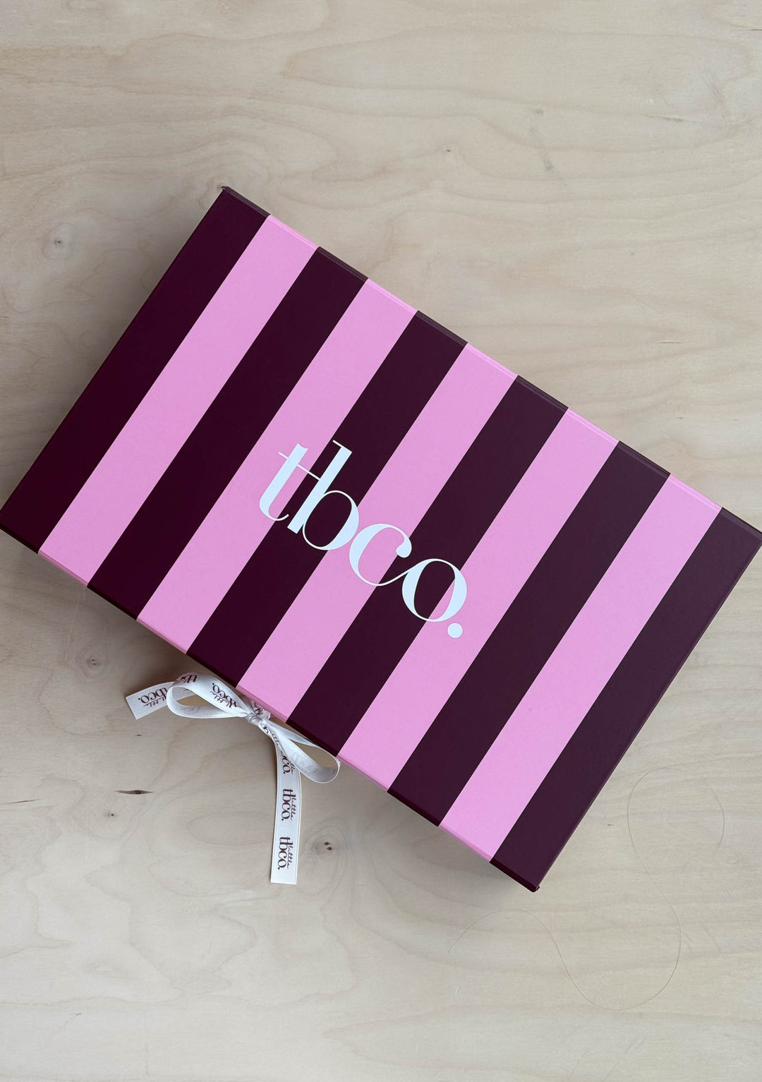 Accessories Gift Box from TBCo with pink and burgundy stripes, shown in gallery position 3, portrait orientation