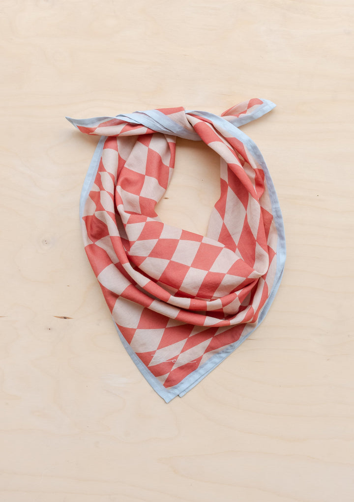 Sample Sale Cotton Square Scarf in Apricot Checkerboard by TBCo laid flat with knotted corner, gallery position 3 portrait view