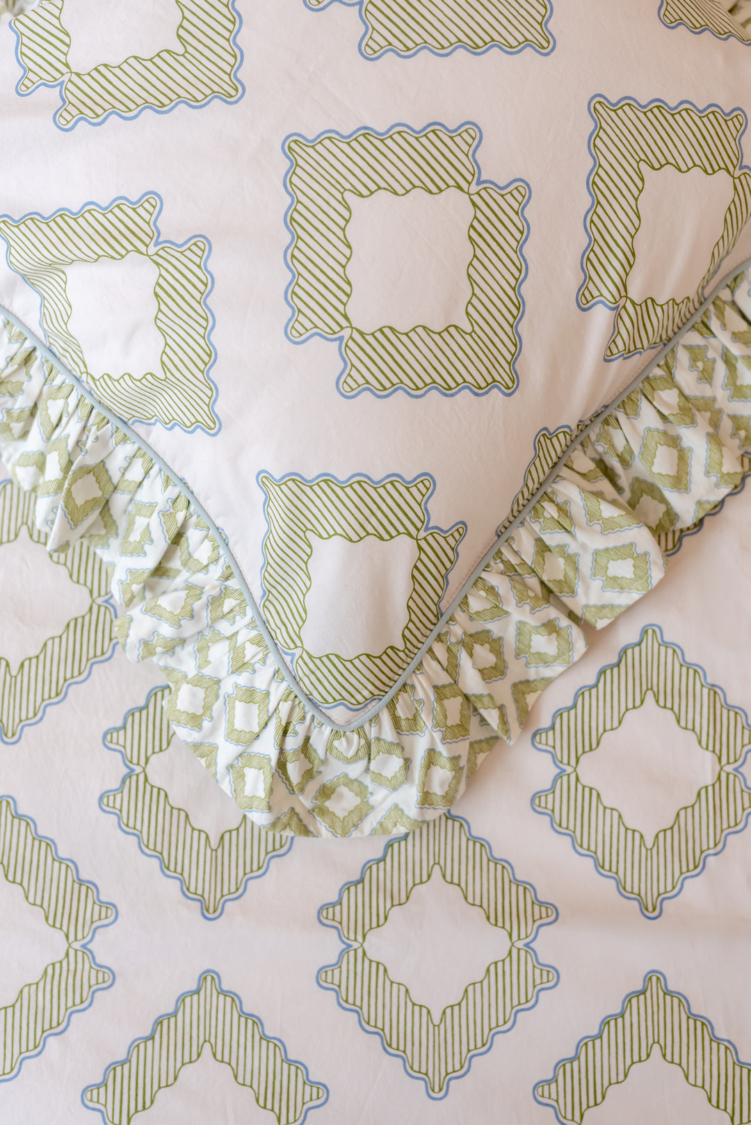 Detailed close-up of TBCo Cotton Duvet Cover & Pillowcases Set in Green Diamond with soft ruffled edges and delicate geometric design
