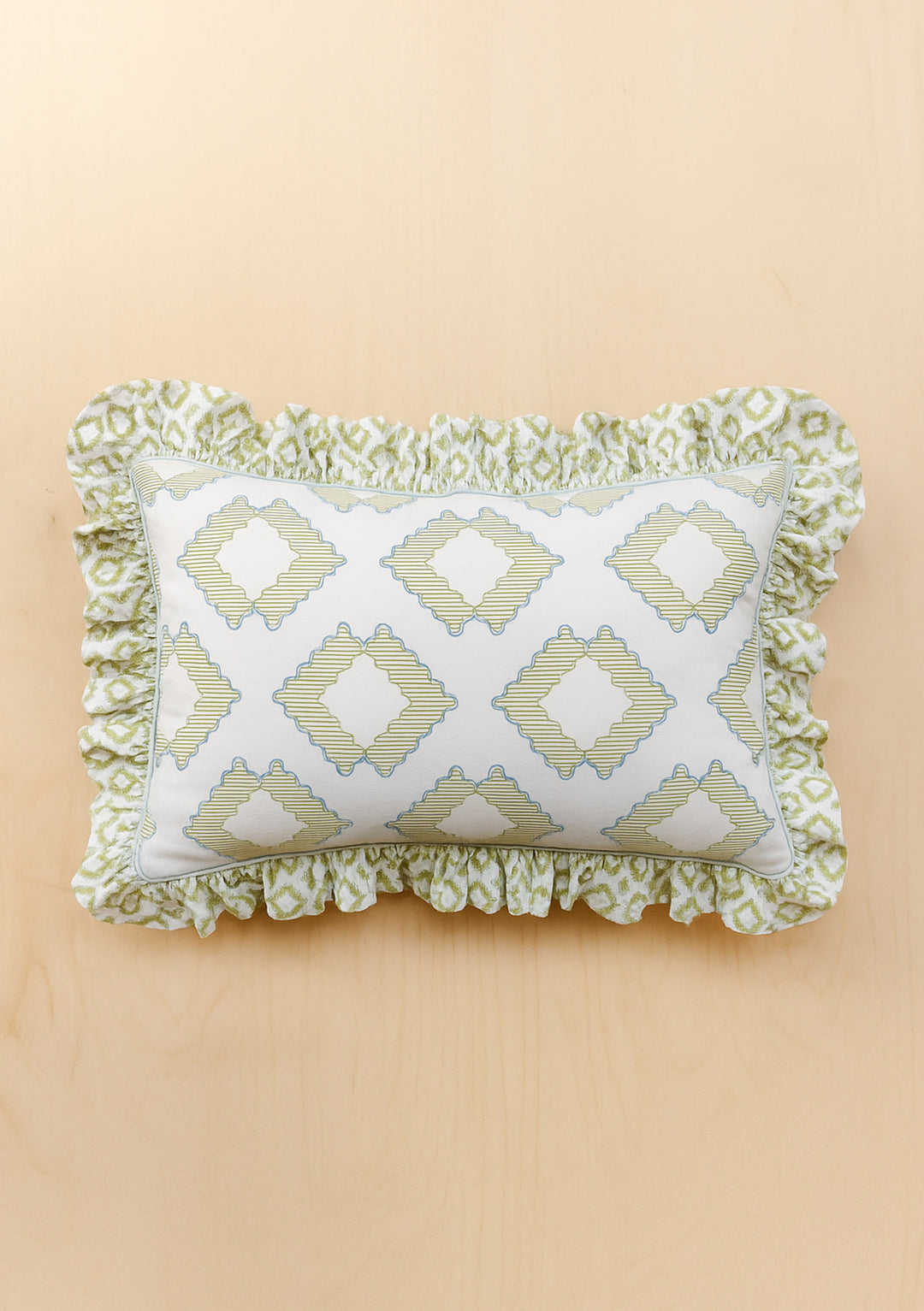 Pair of Cotton Pillowcases in Green Diamond by TBCo featuring ruffled edges and geometric green diamond pattern on pale background
