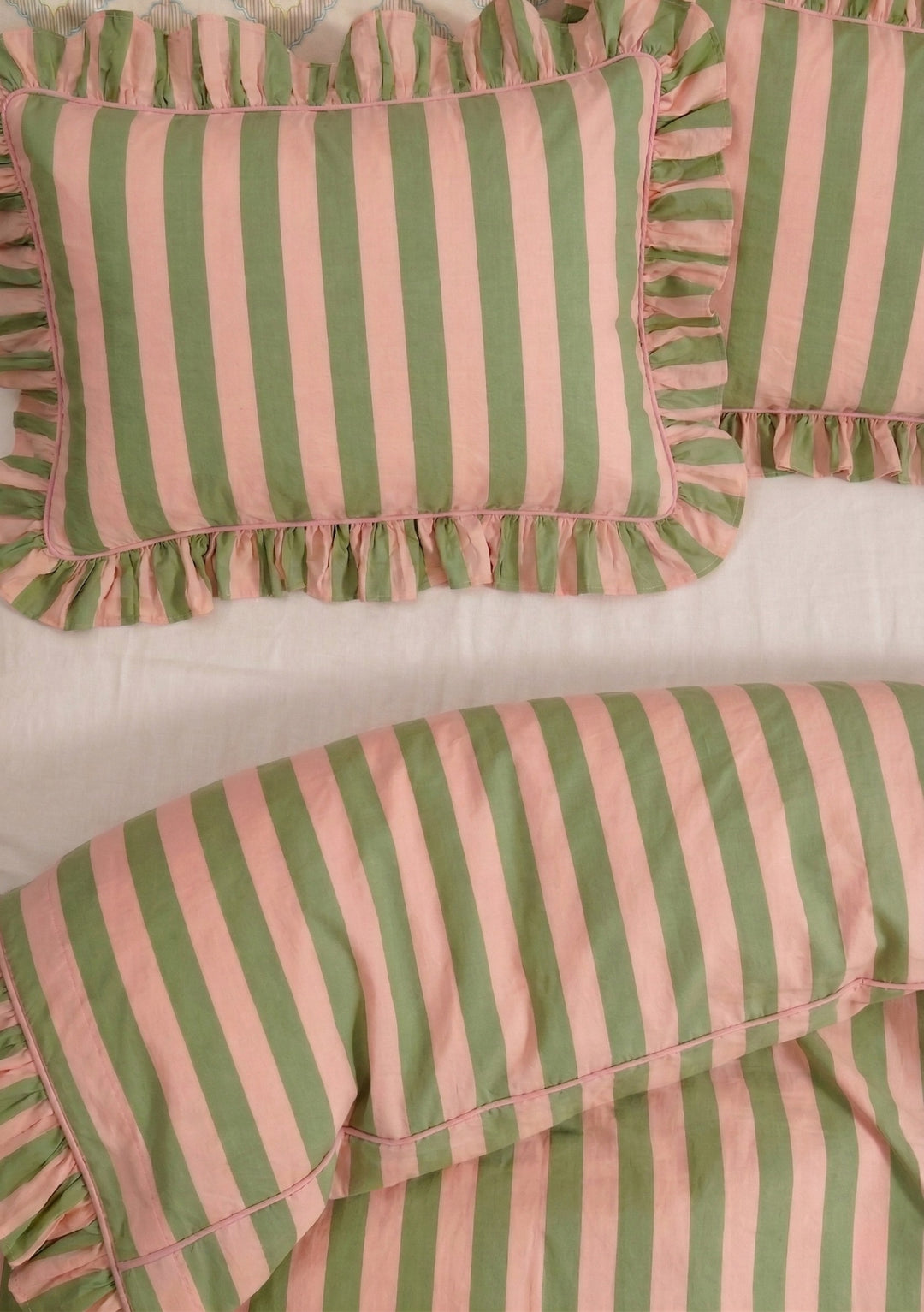 Cotton Duvet Cover & Pillowcases Set in Green Stripe by TBCo with ruffled edges on soft bed linen background