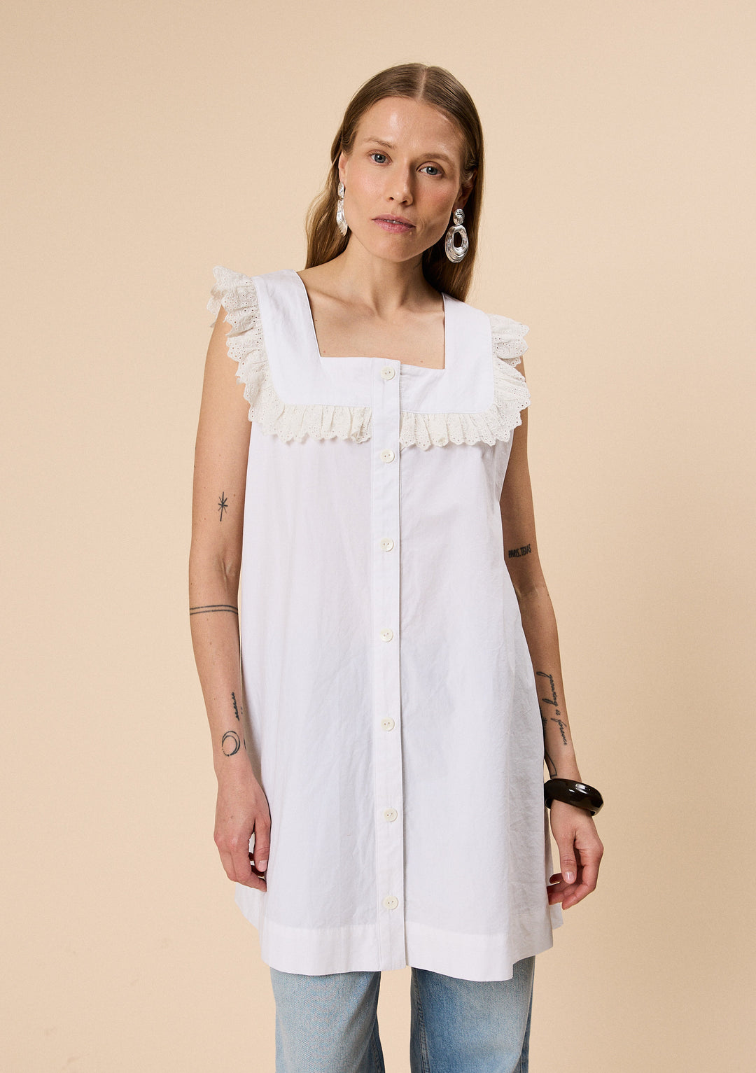 Model wearing TBCo Cotton Broderie Sleeveless Dress in White made with natural and recycled fibres, Certified B-Corp, women-founded, designed to make an impact