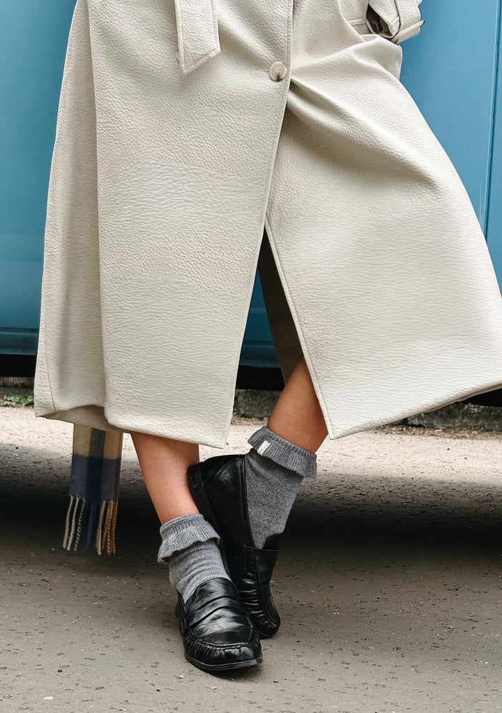 TBCo Merino Wool Socks in Charcoal Frilly worn with black shoes and cream textured coat, showcasing soft wool fabric detail
