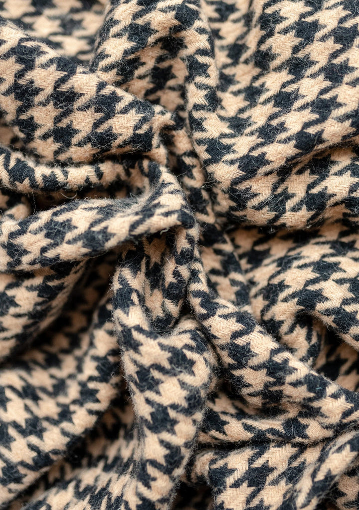 Close-up texture detail of TBCo Lambswool Blanket in Camel Houndstooth pattern showing soft woven wool fabric with classic design