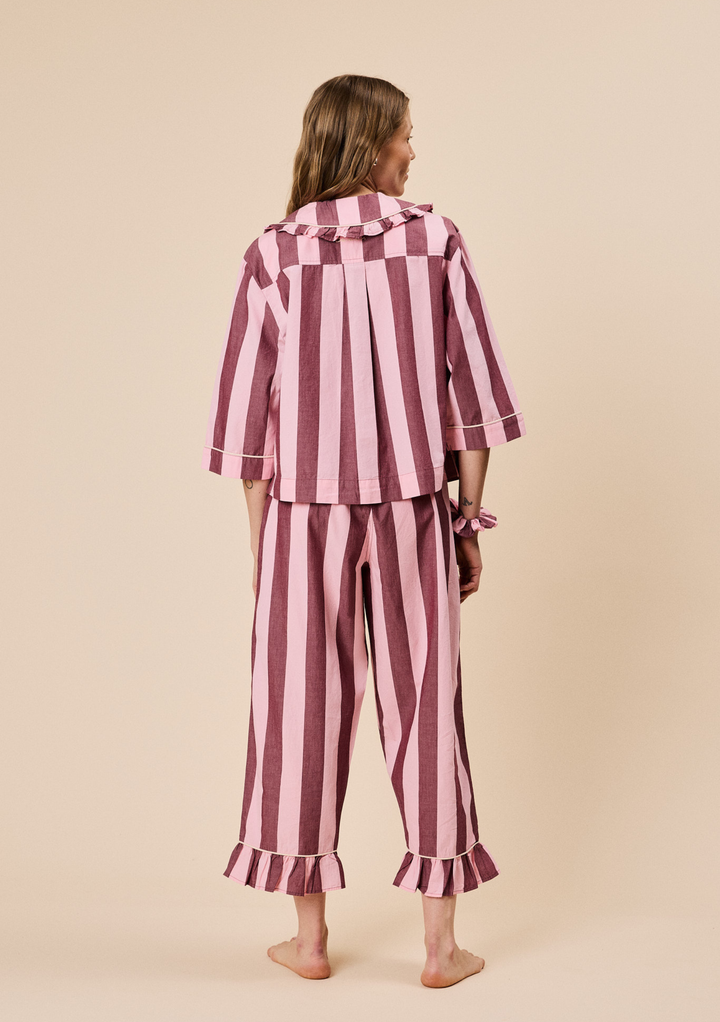 Back view of TBCo Cropped Cotton Pyjamas in Pink & Burgundy Stripe with ruffled collar and frilled cropped hem trousers
