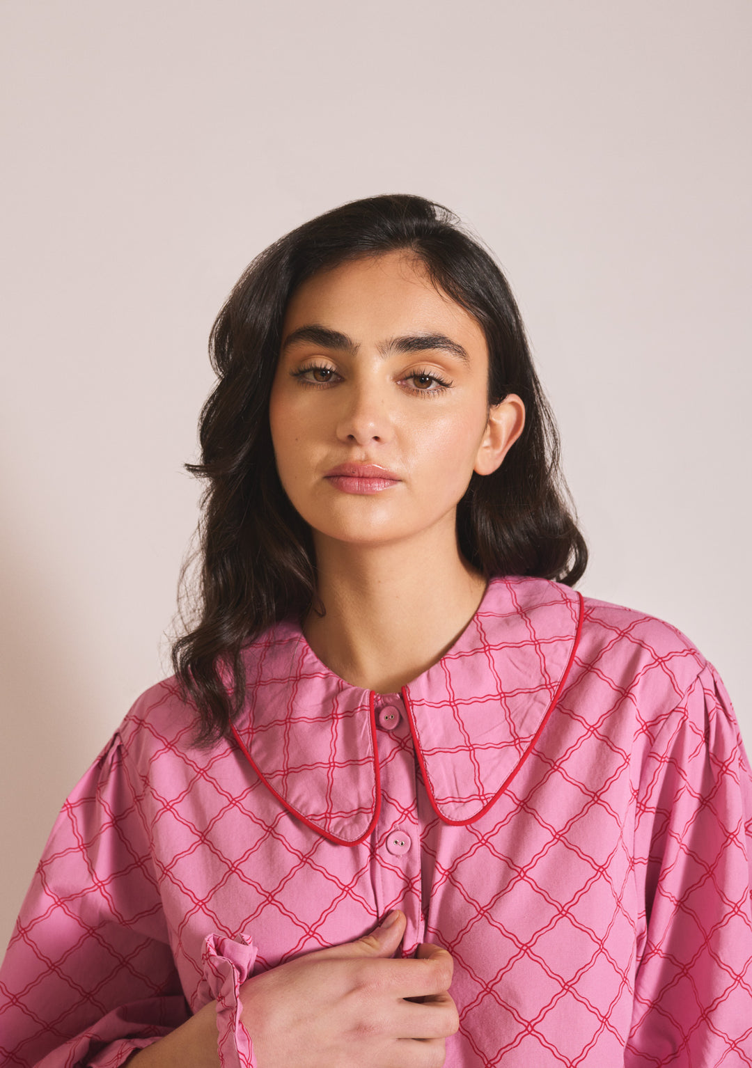 Close-up portrait of model wearing TBCo Cropped Cotton Pyjamas in Pink Lattice, gallery position 4, portrait 1442x2048