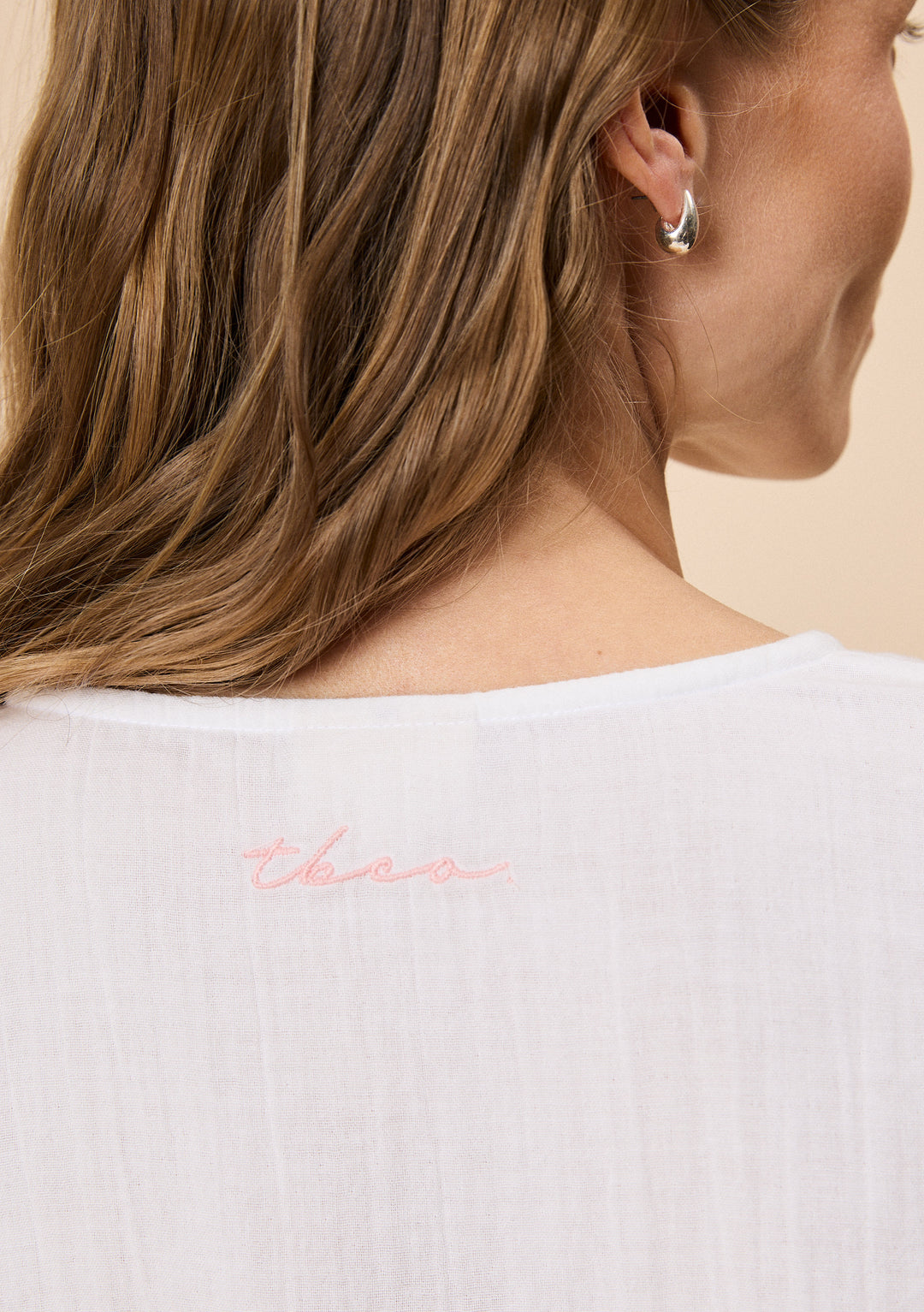Close-up of TBCo Ankle Grazer Cotton Pyjamas in White Ruffle with natural & recycled fibres, Certified B-Corp, Women-Founded, designed to make an impact