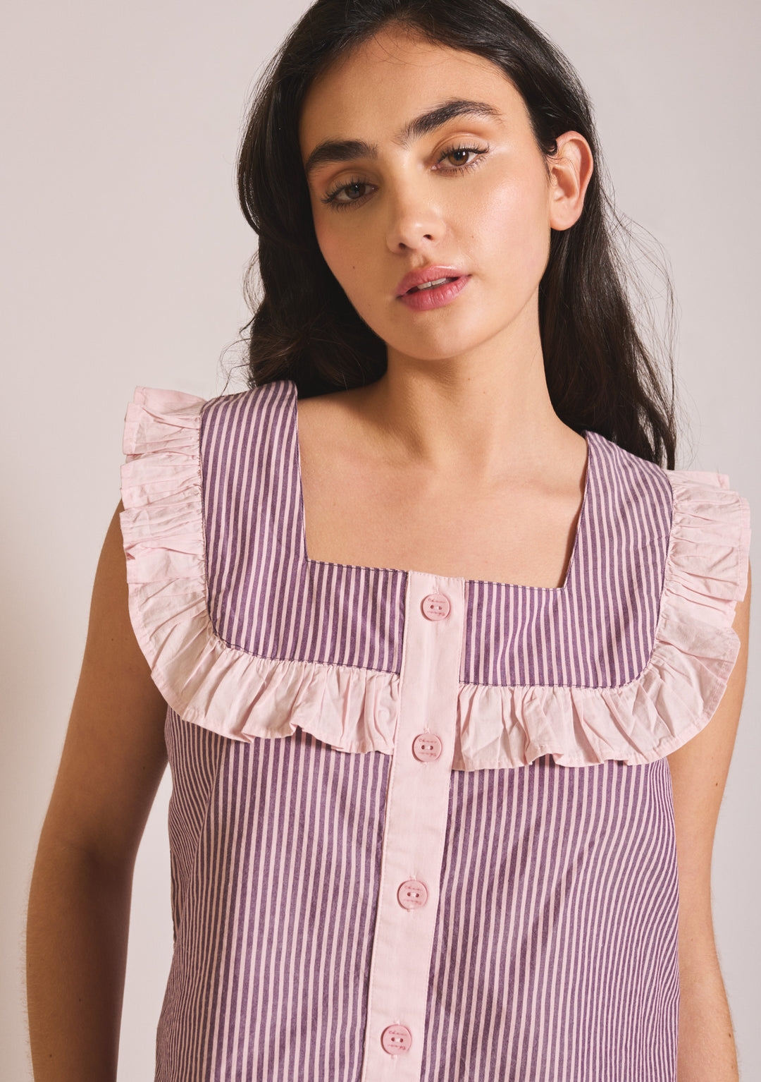 Model wearing TBCo Cropped Cotton Pyjamas in Burgundy Stripe Ruffle, gallery 4 with ruffle detail and button front.