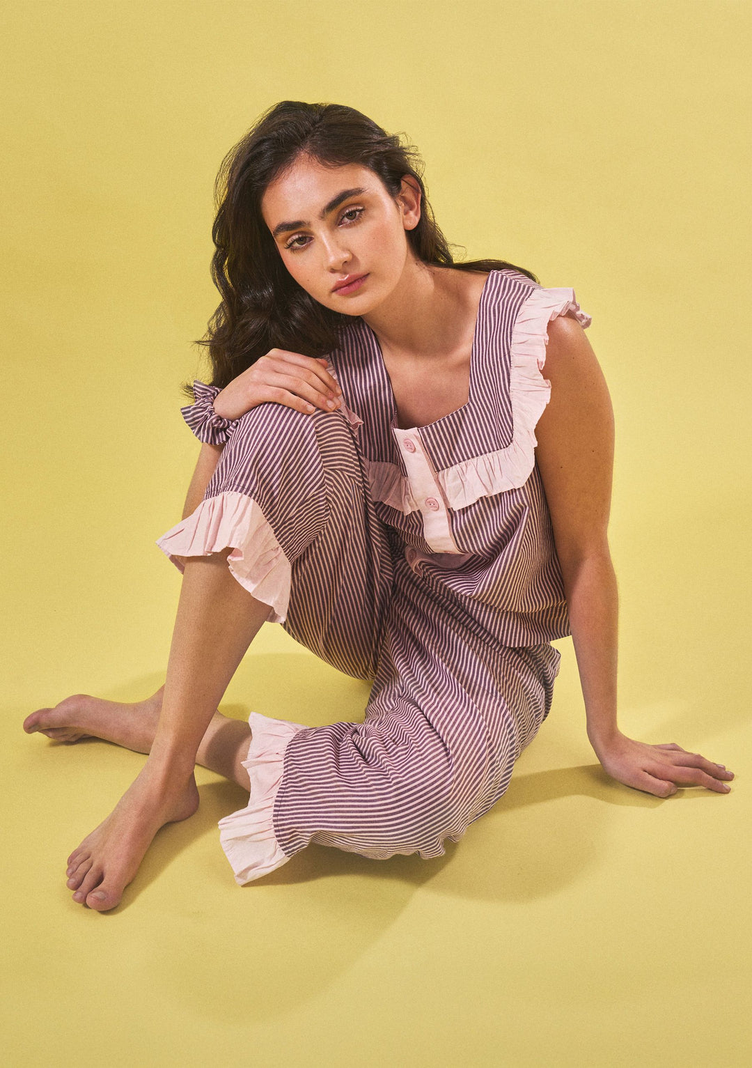 Portrait of model seated wearing TBCo Cropped Cotton Pyjamas in Burgundy Stripe Ruffle, gallery position 2.