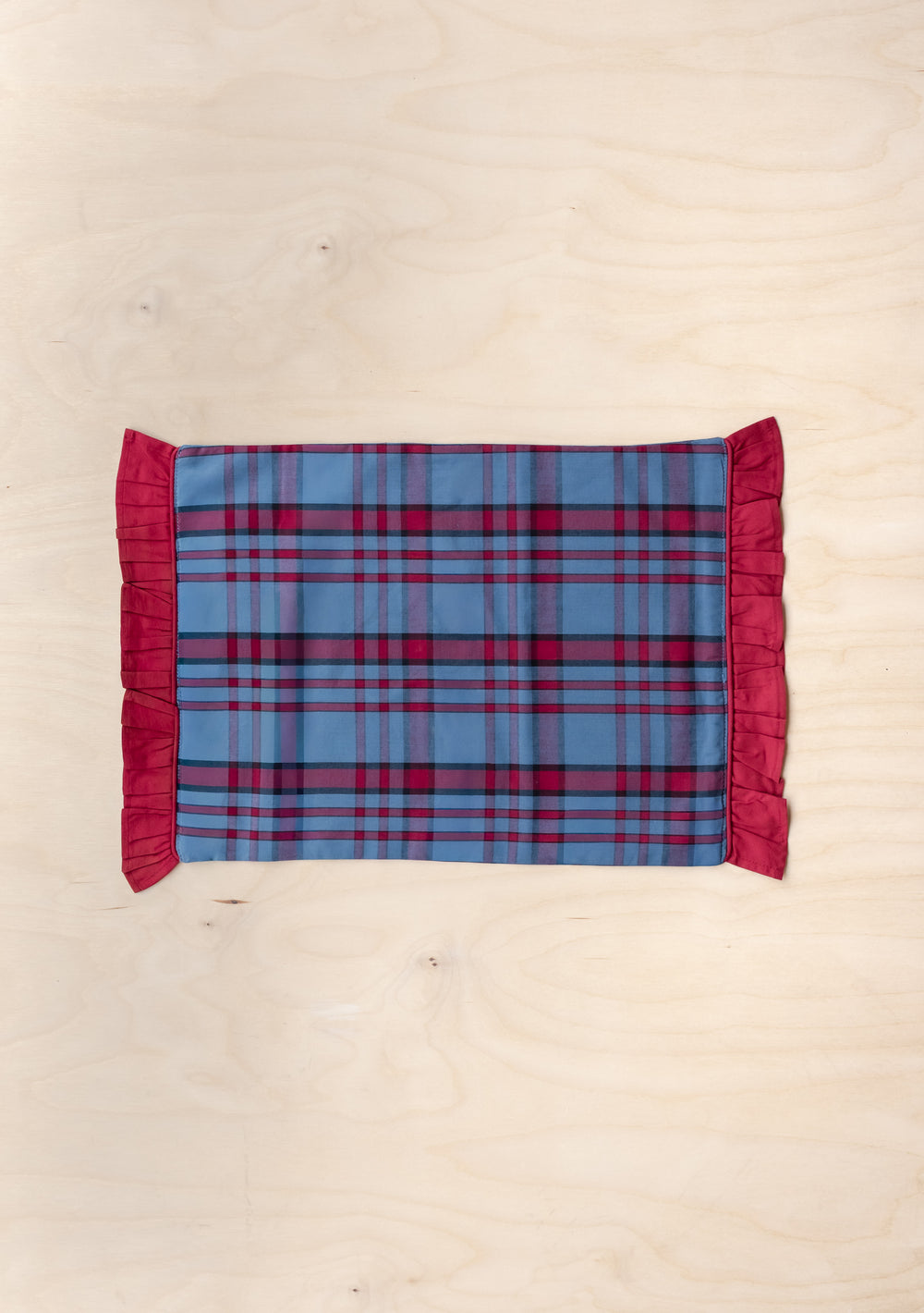 Cotton Placemats Set of 2 in Navy Tartan by TBCo featuring red piping and ruffled edges for a festive table setting