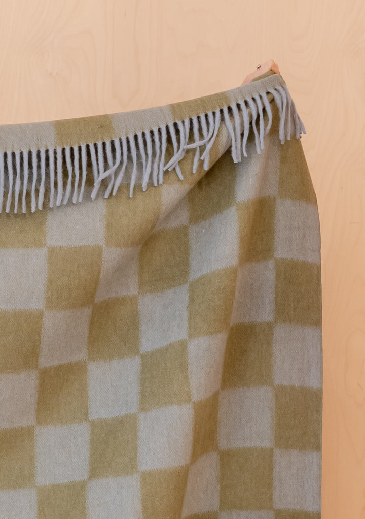 Portrait image gallery position 4 showing fringed TBCo Recycled Wool Blanket in Blue & Green Checkerboard pattern