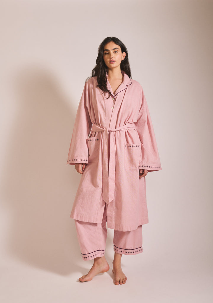 Woman in portrait wearing TBCo Cotton & Linen Robe in Pink with blackberry embroidery, gallery position one, 1442x2048px