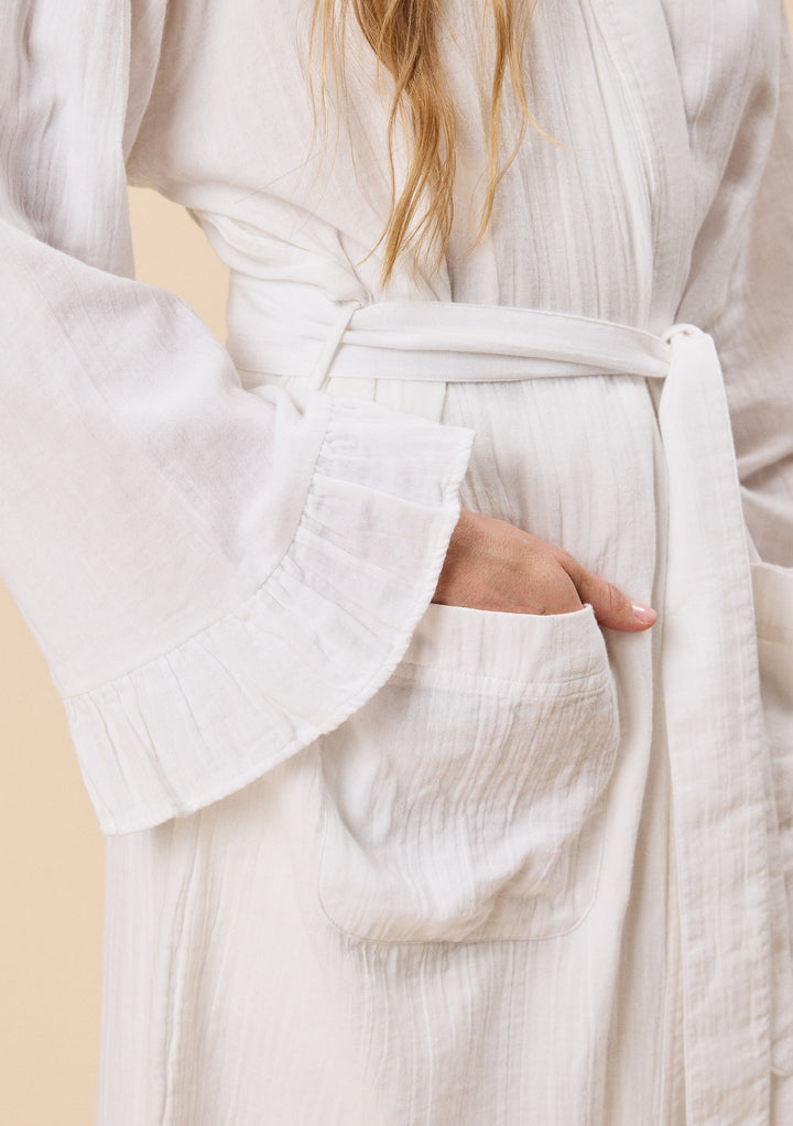 Close-up of TBCo Cotton Robe in White Ruffle with natural and recycled fibres, breathable fabric, Certified B-Corp, women-founded, designed to make an impact