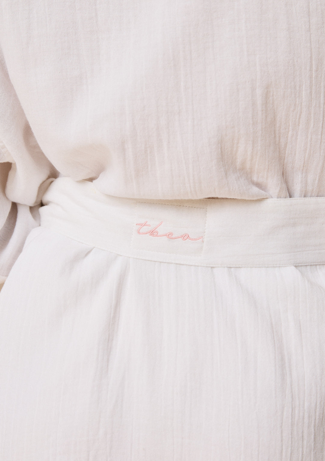 Close-up of TBCo Cotton Robe in White Ruffle featuring breathable natural and recycled fibres, Certified B-Corp, women-founded, designed to make an impact