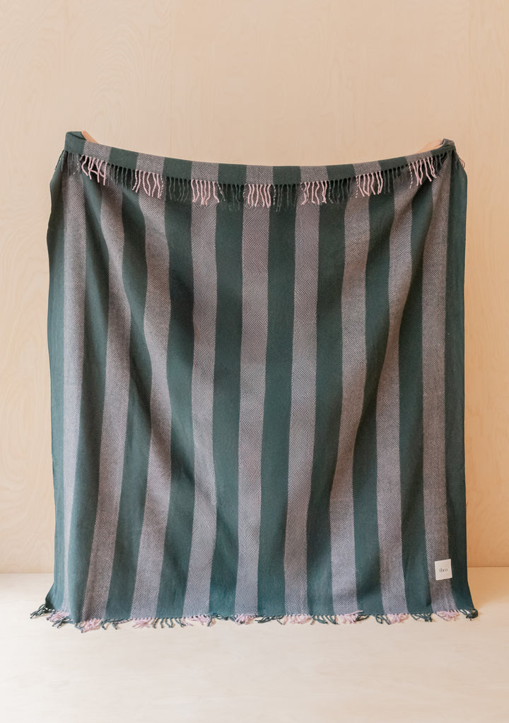 TBCo Sample Sale Recycled Wool Blanket in Pink Diamond Stripe with green and pink striped fringed design hanging flat