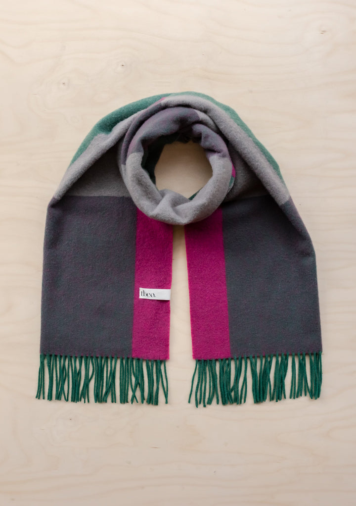 TBCo lambswool oversized scarf in block jacquard pattern featuring grey, green and fuchsia stripes with fringed ends, laid flat