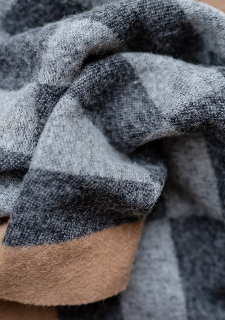 Close-up detail of TBCo's Lambswool Oversized Scarf in Checkerboard Jacquard showing grey and camel wool texture