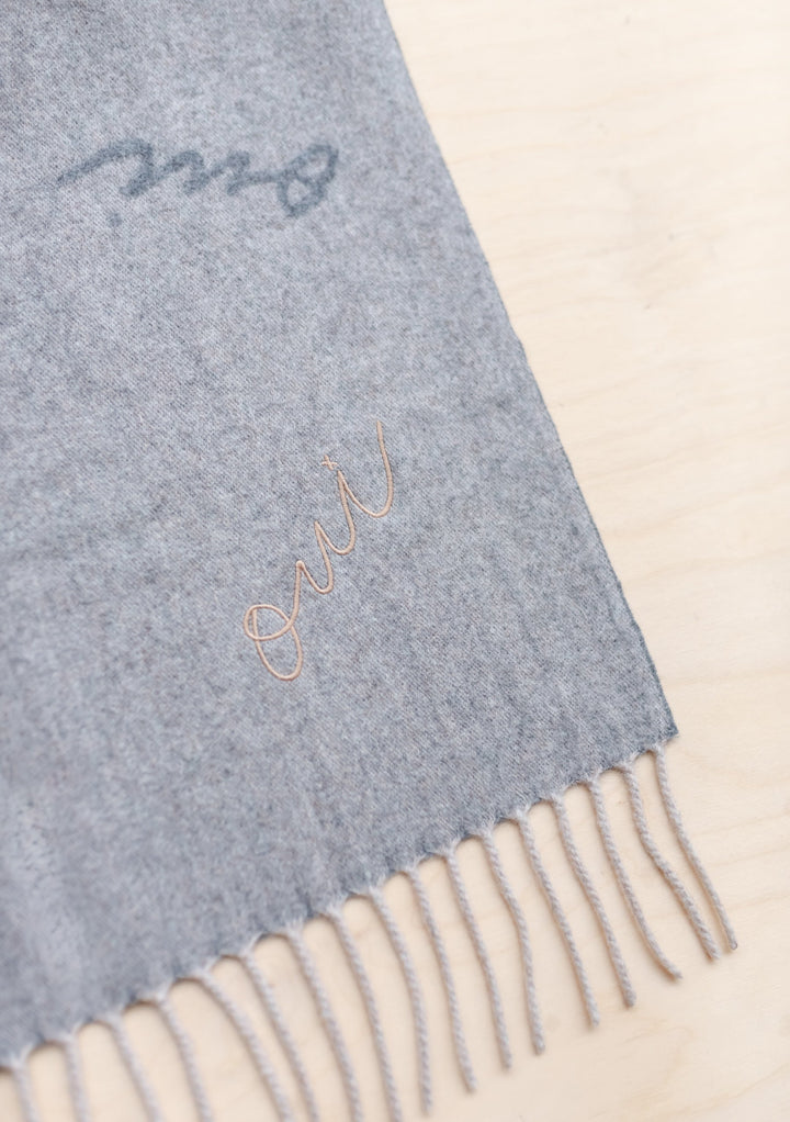 TBCo x Pretty Little Fawn Oui Scarf in grey lambswool with delicate oui embroidery and classic fringed edges