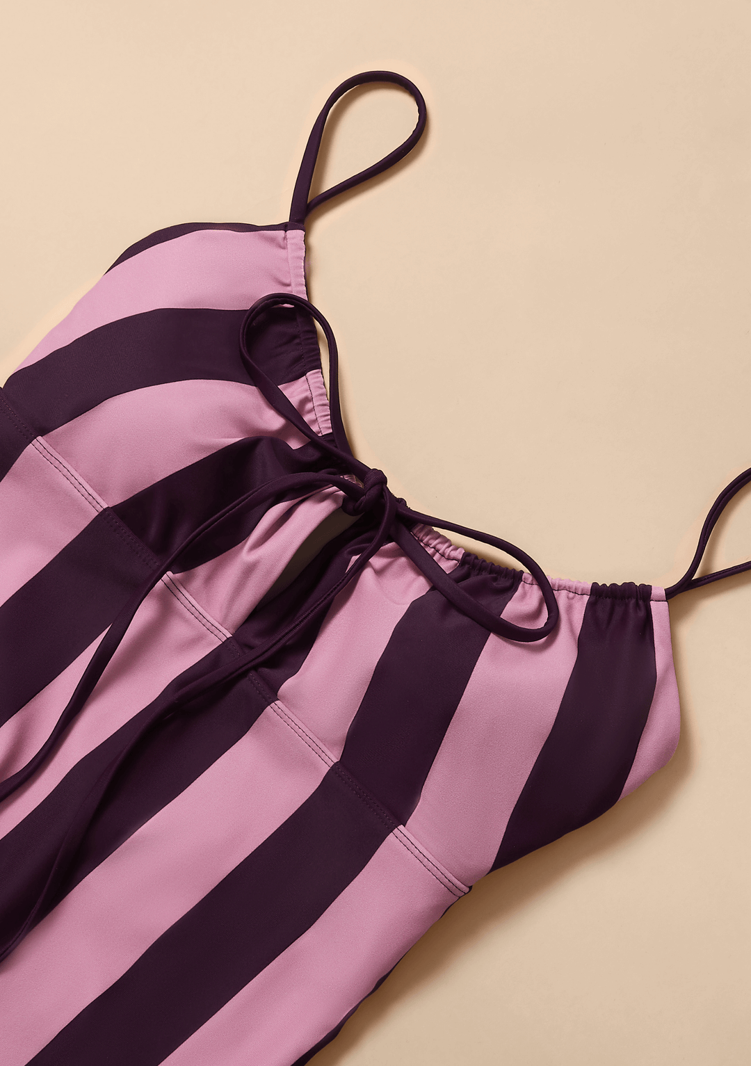 Close up of the TBCo Gathered Swimsuit in Pink & Burgundy Stripe crafted with natural & recycled fibres, Certified B-Corp, Women-Founded, designed to make an impact