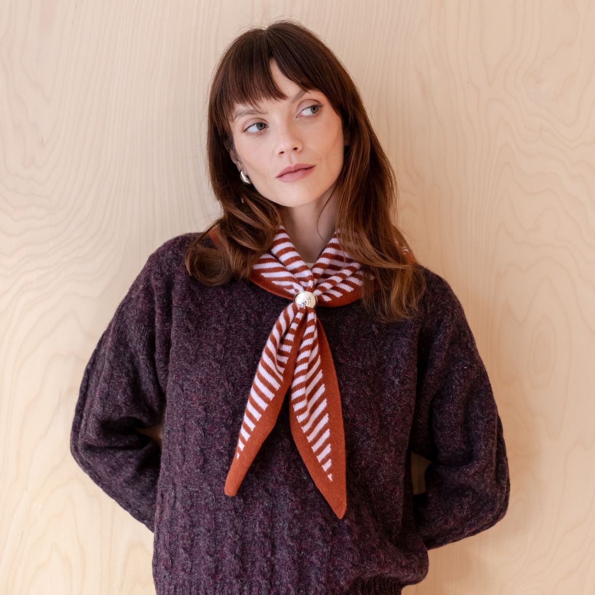 TBCo merino wool triangle scarf in lilac stripes, styled with a textured knit sweater. A chic and cosy seasonal outfit.