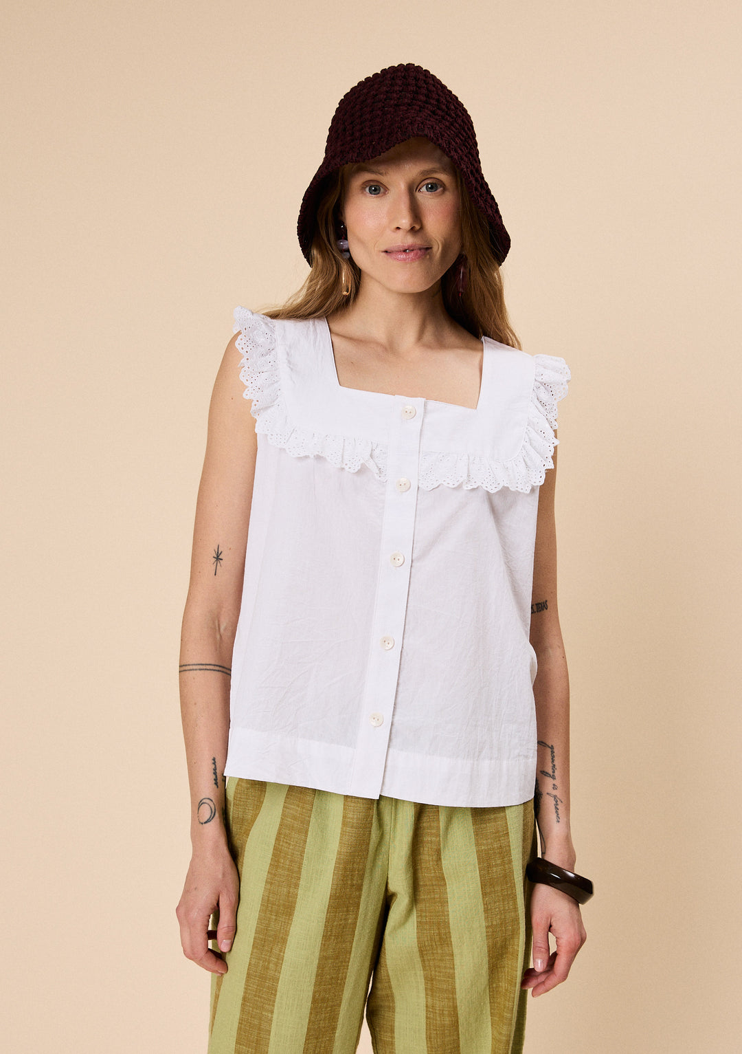 Model wearing TBCo Cotton Broderie Sleeveless Top in White with breathable natural and recycled fibres, Certified B-Corp, Women-Founded, designed to make an impact