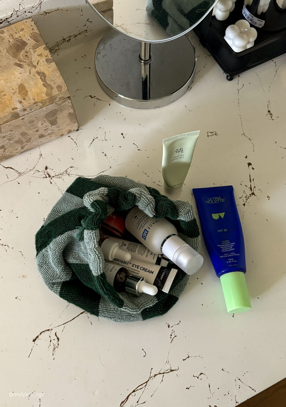 TBCo Terry Cotton Wash Bag in Green Stripe with skincare essentials, crafted from natural fibres, designed to make an impact