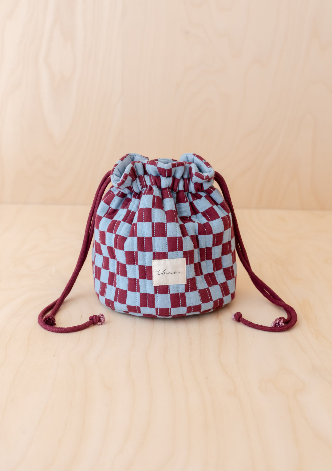Cotton Wash Bag in Blue Checkerboard by TBCo, structured quilted cotton with drawstring, compact and upright design.